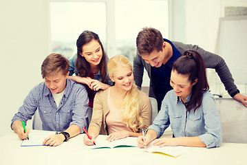 Image showing smiling students with notebooks at school