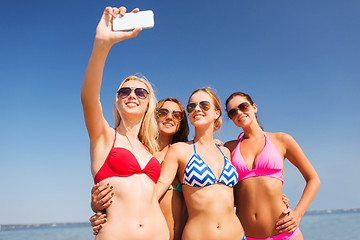 Image showing group of smiling women making selfie on beach