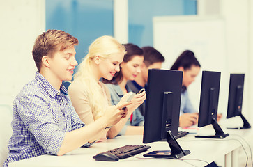 Image showing students with computer monitor and smartphones