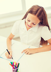 Image showing little student girl drawing at school