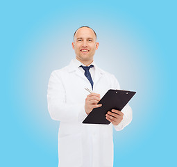 Image showing smiling male doctor with clipboard