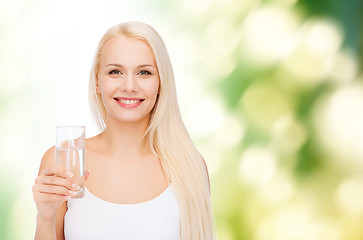 Image showing young smiling woman with glass of water