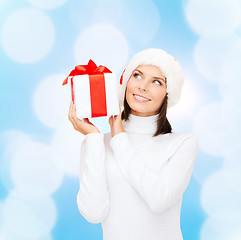 Image showing smiling woman in santa helper hat with gift box