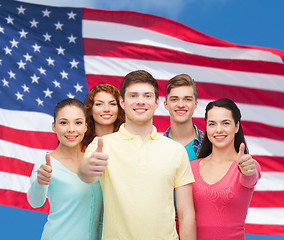 Image showing group of smiling teenagers over american flag