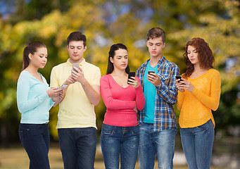 Image showing group of serious teenagers with smartphones