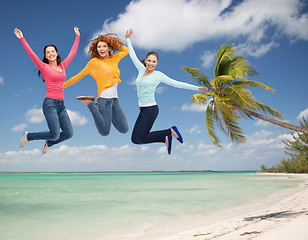 Image showing group of smiling young women jumping in air