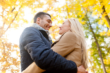 Image showing smiling couple hugging in autumn park