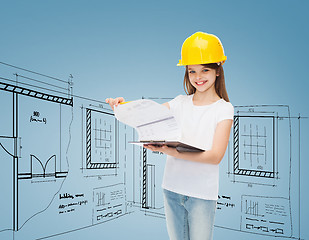 Image showing smiling little girl in hardhat with clipboard