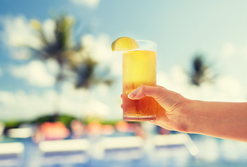 Image showing close-up of hand holding glass with cocktail