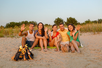 Image showing smiling friends in sunglasses on summer beach