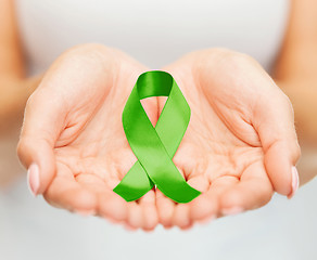 Image showing hands holding green awareness ribbon