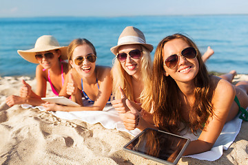 Image showing group of smiling young women with tablets on beach