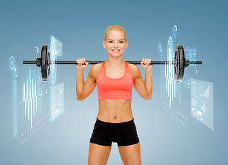 Image showing smiling sporty woman exercising with barbell