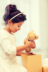 Image showing happy child girl with gift box and teddy bear