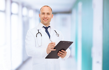 Image showing smiling male doctor with clipboard and stethoscope