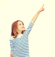 Image showing smiling girl pointing at virtual screen