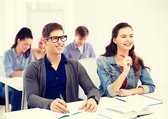 Image showing smiling students with notebooks at school