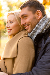 Image showing smiling couple hugging in autumn park