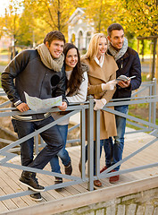 Image showing group of friends with map outdoors