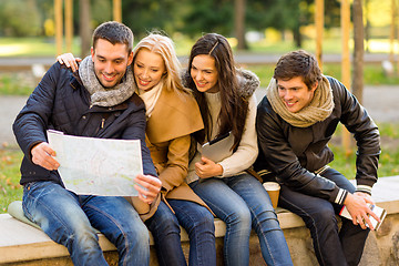 Image showing group of friends with map outdoors