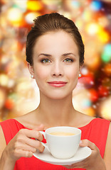 Image showing smiling woman in red dress with cup of coffee