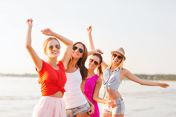 Image showing group of smiling women dancing on beach