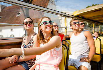 Image showing group of smiling friends traveling by tour bus