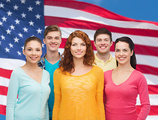 Image showing group of smiling teenagers over american flag