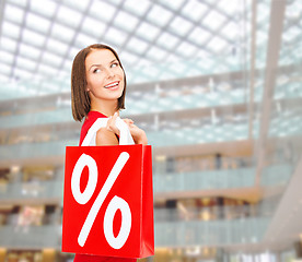 Image showing woman in red dress with shopping bags