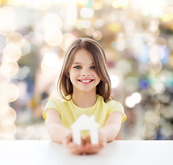 Image showing beautiful little girl holding paper house cutout