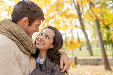 Image showing smiling couple hugging in autumn park