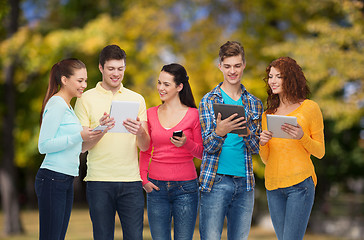 Image showing group of teenagers with smartphones and tablet pc