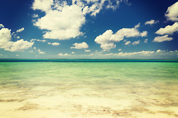 Image showing blue sea or ocean, white sand and sky with clouds