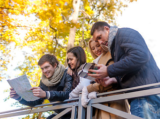 Image showing group of friends with map outdoors