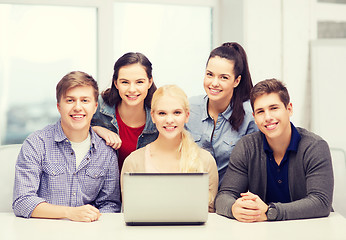 Image showing smiling students with laptop at school