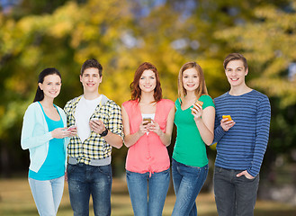 Image showing smiling students with smartphones