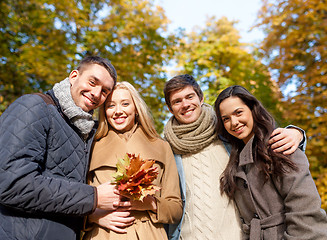 Image showing group of smiling men and women in autumn park