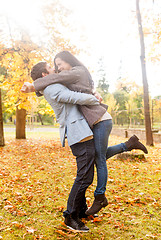 Image showing smiling couple hugging in autumn park