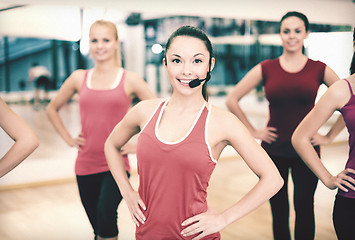 Image showing group of smiling people exercising in the gym