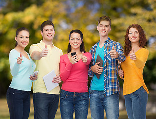 Image showing group of teenagers with smartphones and tablet pc