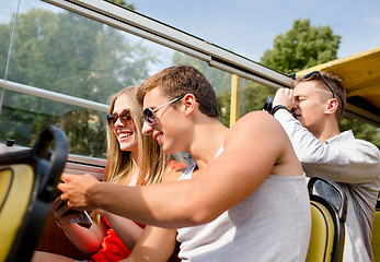 Image showing smiling couple with book traveling by tour bus