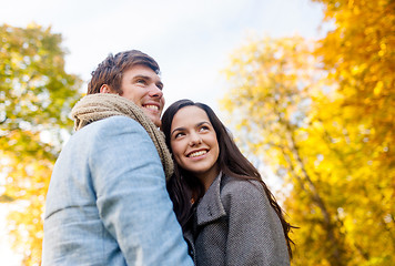 Image showing smiling couple hugging in autumn park