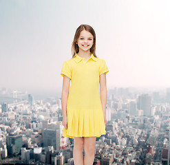 Image showing smiling little girl in yellow dress