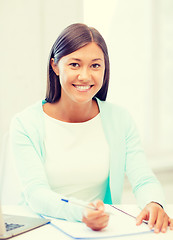 Image showing asian businesswoman with laptop and documents