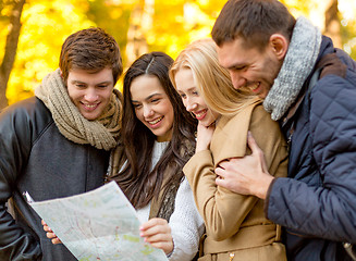 Image showing group of friends with map outdoors