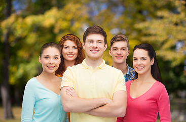 Image showing group of smiling teenagers over green park