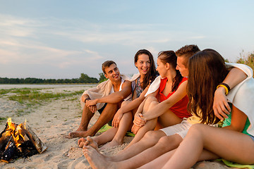 Image showing smiling friends in sunglasses on summer beach