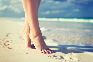 Image showing closeup of woman legs on sea shore