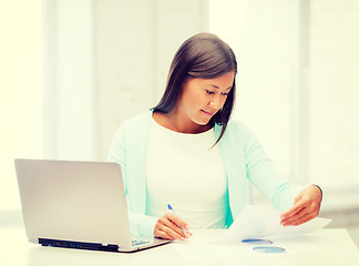 Image showing asian businesswoman with laptop and documents