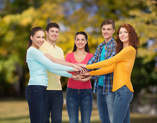 Image showing group of smiling teenagers over green park